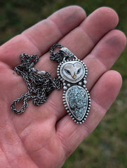 Handmade owl pendant in hand for size reference